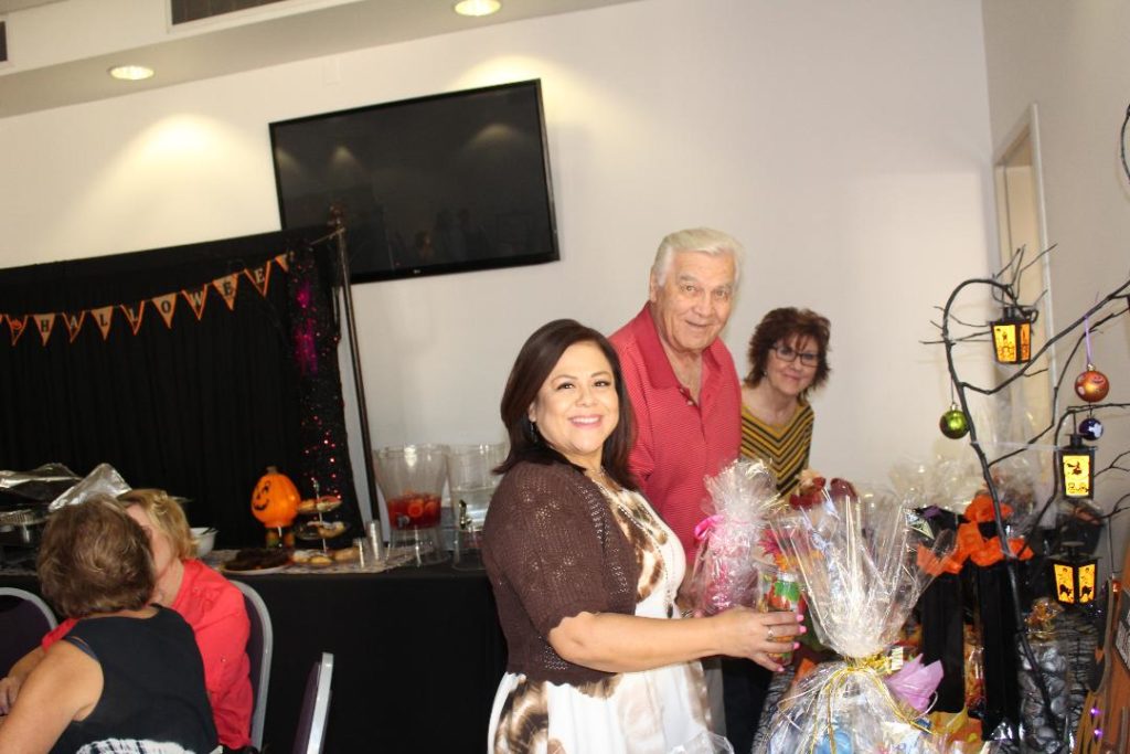 Volunteers Patty Cabrera, Phil Merchant and Laurel Martinez picking out their door prizes. Everyone who attended won a prize!